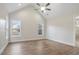 Bedroom with vaulted ceiling, ceiling fan, two windows providing natural light, and wood-look floors at 602 Sandhill Hickory Level Rd, Carrollton, GA 30116