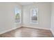 Bedroom with hardwood flooring and two windows offering natural light and outdoor views at 602 Sandhill Hickory Level Rd, Carrollton, GA 30116
