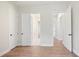 Bedroom featuring hardwood floors and multiple doorways providing easy access throughout the home at 602 Sandhill Hickory Level Rd, Carrollton, GA 30116