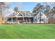 Beautiful craftsman-style home with a blue exterior, large front yard, and charming front porch with wooden posts at 602 Sandhill Hickory Level Rd, Carrollton, GA 30116