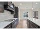 Stylish kitchen featuring dark wood cabinets, stainless steel appliances, and a center island with a white countertop at 602 Sandhill Hickory Level Rd, Carrollton, GA 30116