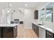 Bright kitchen features stainless appliances, dark cabinets, an island, and an open floor plan at 602 Sandhill Hickory Level Rd, Carrollton, GA 30116