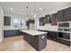 Modern kitchen with dark wood cabinets, a center island, white countertops, and stainless steel appliances at 602 Sandhill Hickory Level Rd, Carrollton, GA 30116