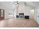 Bright living room features vaulted ceilings, a fireplace, and hardwood floors, exuding warmth and style at 602 Sandhill Hickory Level Rd, Carrollton, GA 30116