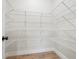 Walk-in pantry features wire shelving and wood-look floors for optimal organization at 602 Sandhill Hickory Level Rd, Carrollton, GA 30116