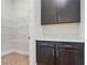 Pantry features shelving, a countertop, and dark cabinets providing ample storage space at 602 Sandhill Hickory Level Rd, Carrollton, GA 30116