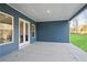 Covered patio with concrete floor, and double doors that allows access to the outside of the home at 602 Sandhill Hickory Level Rd, Carrollton, GA 30116