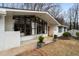 The home's exterior shows painted white brick, and a large picture window providing great natural light at 665 Lake Charles Way, Roswell, GA 30075