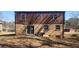 Back exterior view of the property featuring a brick facade, siding, sliding glass doors, and small patio area at 3747 Southland Ct, Atlanta, GA 30344