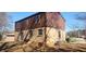 Back exterior view of the property featuring a brick facade, siding, sliding glass doors, and small patio area at 3747 Southland Ct, Atlanta, GA 30344