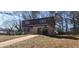View of the front exterior of a two story home featuring a brick facade, attached garage, and long driveway at 3747 Southland Ct, Atlanta, GA 30344