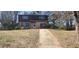Two-story home with a brick facade on the lower half and siding on the upper half and an attached one car garage at 3747 Southland Ct, Atlanta, GA 30344