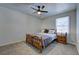 Cozy bedroom featuring a classic wooden bed frame, ceiling fan, and carpet floors at 6700 Roswell Rd # 32C, Atlanta, GA 30328