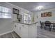 Bright dining area with a granite-topped island, a table and chairs, and stylish lighting at 6700 Roswell Rd # 32C, Atlanta, GA 30328