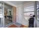 Inviting entryway with wood floors, brick accents, and a view into the kitchen at 6700 Roswell Rd # 32C, Atlanta, GA 30328