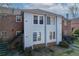 Well-maintained townhome featuring gray siding, brick accents, and black iron staircases leading to the upper level at 6700 Roswell Rd # 32C, Atlanta, GA 30328