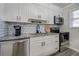 Modern kitchen with white cabinetry, stainless steel appliances, and granite countertops at 6700 Roswell Rd # 32C, Atlanta, GA 30328