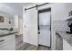 A convenient laundry closet hidden behind a modern barn door off of the kitchen and dining space at 6700 Roswell Rd # 32C, Atlanta, GA 30328