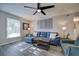 Cozy living room with a modern ceiling fan, gray walls, and a comfortable blue sectional sofa at 6700 Roswell Rd # 32C, Atlanta, GA 30328