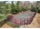 A tennis court surrounded by mature trees and fencing is ready for recreational enjoyment and play at 6700 Roswell Rd # 32C, Atlanta, GA 30328