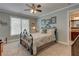 Cozy bedroom featuring a large bed with a floral comforter, side tables, and walls adorned with picturesque art at 103 Old Avery Dr, Canton, GA 30115
