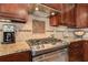 Close-up of the kitchen with a stainless steel range and custom tile backsplash at 103 Old Avery Dr, Canton, GA 30115