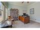 Well-lit home office with custom bookshelf, large windows, and a classic wooden desk at 103 Old Avery Dr, Canton, GA 30115