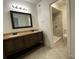 Bathroom featuring double sink vanity with granite countertops and tiled shower at 3060 Parc Lorraine, Lithonia, GA 30038