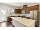 Modern kitchen with stainless steel appliances, marble countertops, and dark wood cabinets at 709 Bismark Ne Rd, Atlanta, GA 30324