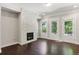 Stylish living room with a fireplace, two doors to a balcony, and hardwood floors at 709 Bismark Ne Rd, Atlanta, GA 30324