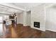 Open concept living room with a stone fireplace, hardwood floors, and a view of the modern kitchen at 709 Bismark Ne Rd, Atlanta, GA 30324