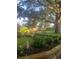 This backyard has beautiful landscaping, mature trees, a hammock, and a stone patio for lounging at 2295 Hemrick Rd, Cumming, GA 30041