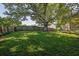 Well-maintained, fenced backyard with mature tree and lawn at 2295 Hemrick Rd, Cumming, GA 30041