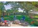 Inviting backyard features a paver patio with firepit and seating, swing, and lush, fenced lawn at 2295 Hemrick Rd, Cumming, GA 30041