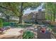 Beautiful backyard with a brick patio, mature trees, a swing, and ample seating at 2295 Hemrick Rd, Cumming, GA 30041