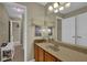 This bathroom vanity has double sinks, a mirror and unique overhead lighting at 2295 Hemrick Rd, Cumming, GA 30041