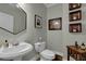 Modern bathroom features a pedestal sink, tile flooring, and lovely decor accents at 2295 Hemrick Rd, Cumming, GA 30041