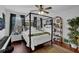 Bedroom features a canopy bed, piano, and a decorative plant at 2295 Hemrick Rd, Cumming, GA 30041