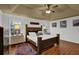 This bedroom has a ceiling fan, tray ceiling, and hardwood floors at 2295 Hemrick Rd, Cumming, GA 30041