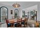 Elegant dining room featuring a stylish light fixture and large windows that let in plenty of natural light at 2295 Hemrick Rd, Cumming, GA 30041