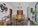 Bright dining room features refinished concrete floors, lovely light fixture, and nice built-in storage at 2295 Hemrick Rd, Cumming, GA 30041