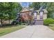 Charming two-story home with a well-manicured lawn, beautiful landscaping, and an attached two-car garage at 2295 Hemrick Rd, Cumming, GA 30041