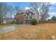 Traditional two-story home with a two-car garage, brick facade, and well-manicured lawn and landscape at 2295 Hemrick Rd, Cumming, GA 30041