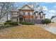 Charming two-story home with a brick and siding exterior, a well-maintained lawn, and mature landscaping at 2295 Hemrick Rd, Cumming, GA 30041