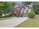 Charming two-story home with a well-manicured lawn, beautiful landscaping, and an attached two-car garage at 2295 Hemrick Rd, Cumming, GA 30041