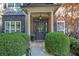 Welcoming front entrance featuring a classic door, sidelights, and decorative landscaping at 2295 Hemrick Rd, Cumming, GA 30041