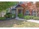 Beautiful brick and siding home with a manicured lawn and walkway leading to the front entrance at 2295 Hemrick Rd, Cumming, GA 30041