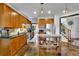 Well-lit kitchen featuring wooden cabinets, stainless steel appliances, and center kitchen island at 2295 Hemrick Rd, Cumming, GA 30041