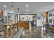 Open kitchen layout with stainless steel refrigerator, eat-in area, and refinished concrete floors at 2295 Hemrick Rd, Cumming, GA 30041