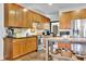 Charming kitchen featuring wooden cabinets, stainless steel appliances, and a movable kitchen island at 2295 Hemrick Rd, Cumming, GA 30041